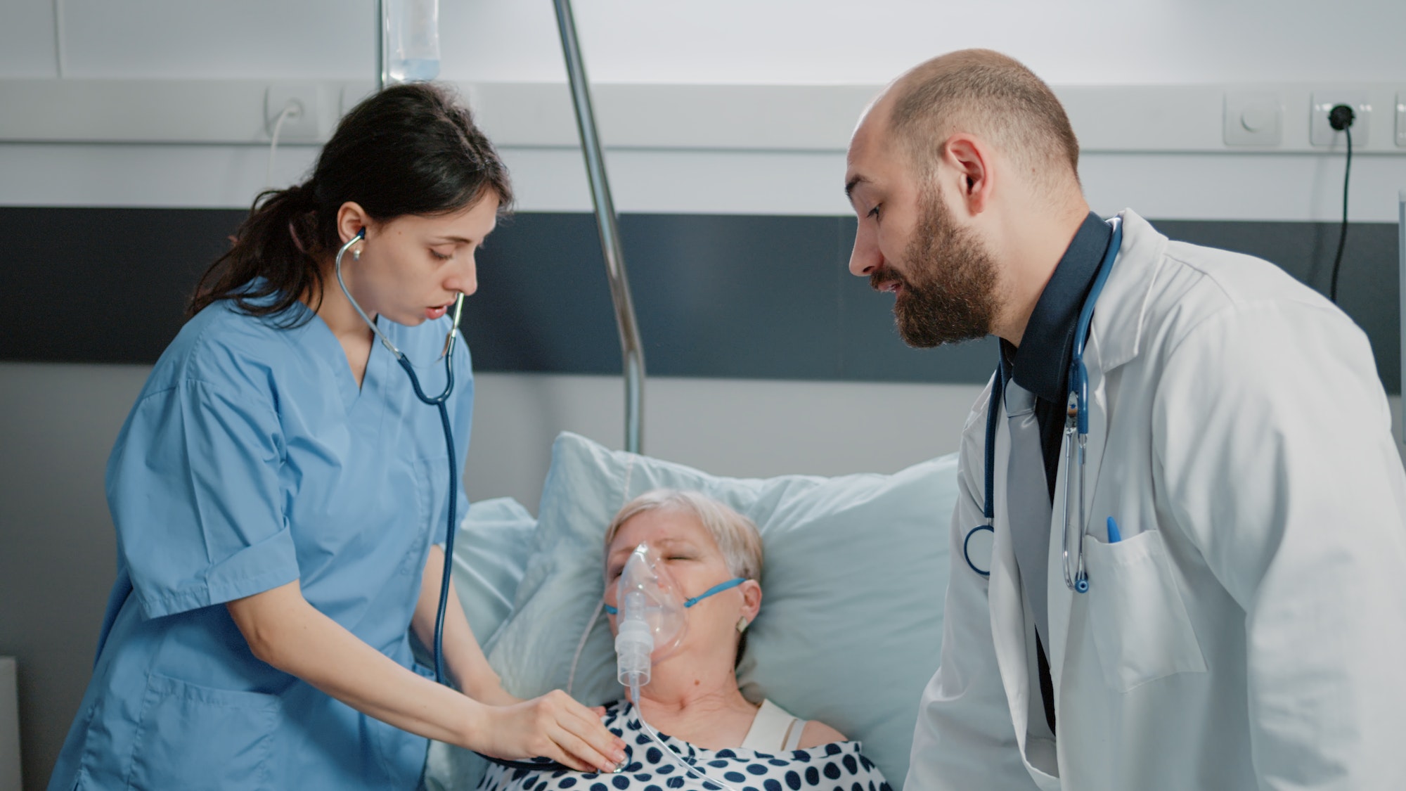 Medical team helping patient with respiratory disease