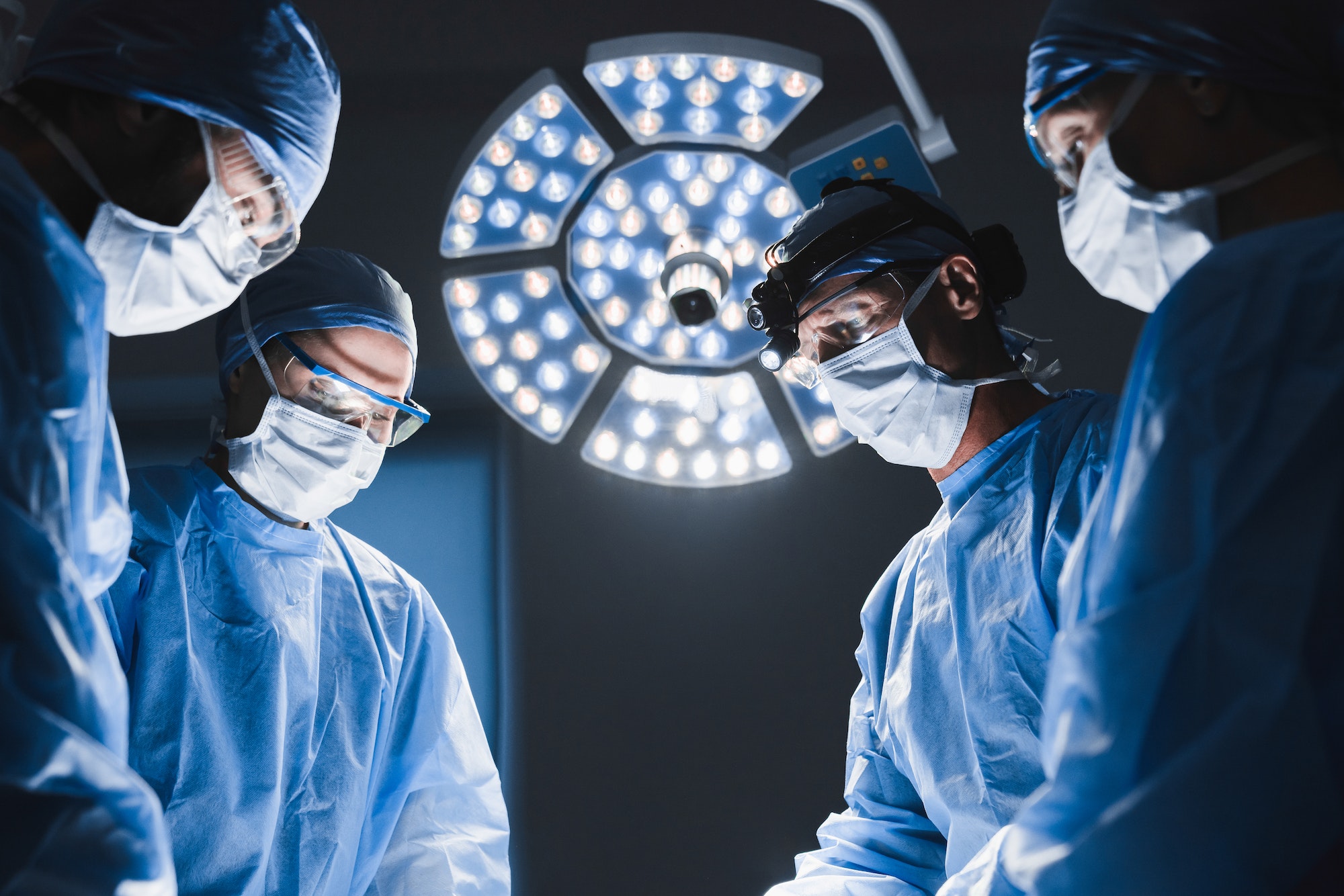 Team surgeon at work in operating room.